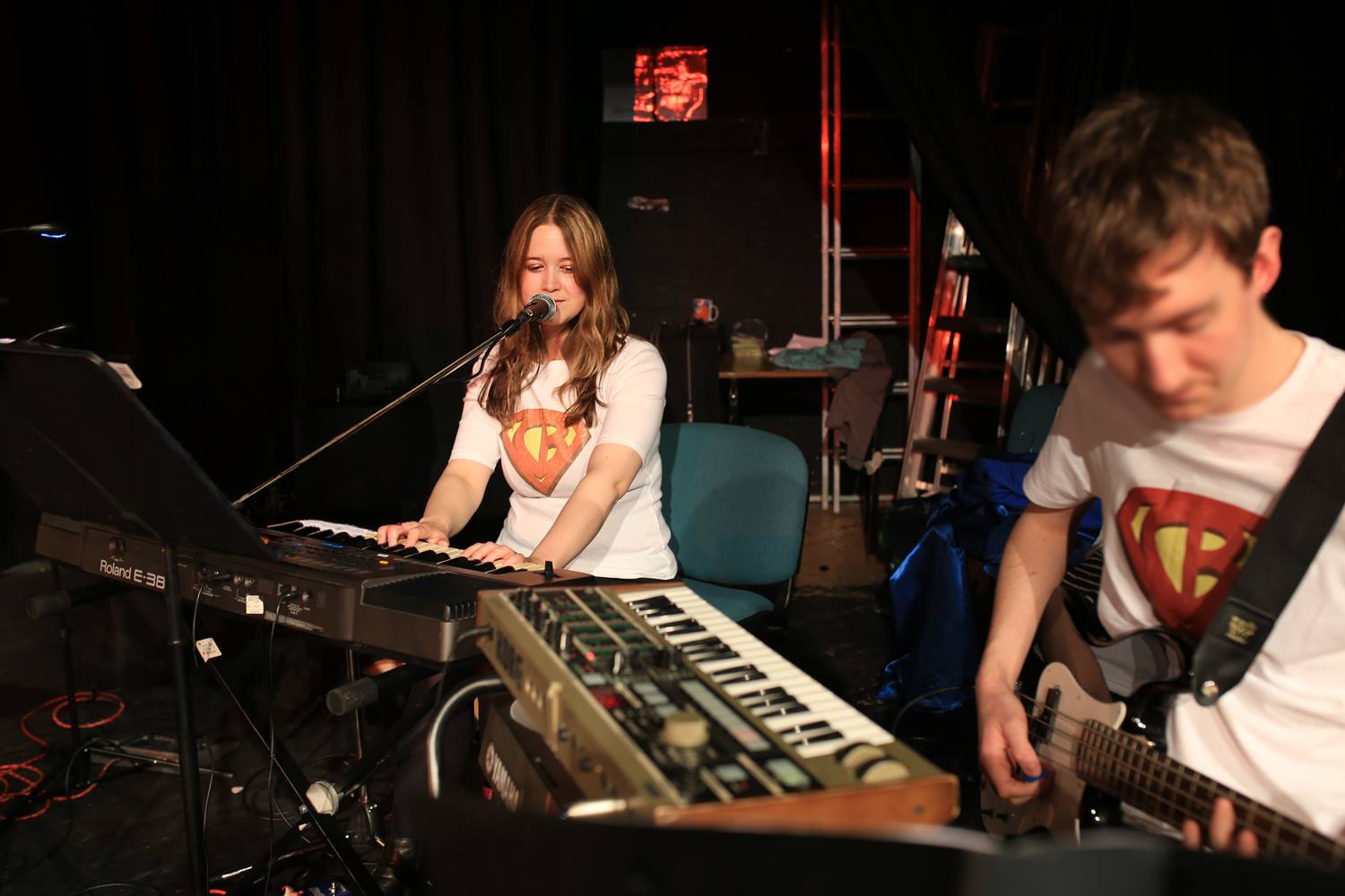Two people performing music in a theatre